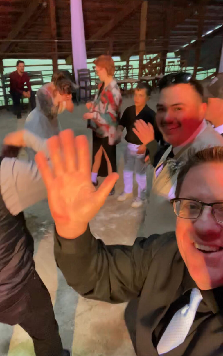 DJ waving at the wedding reception guests, portapixie